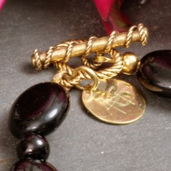 Armband Rosa Jade, Detailansicht vom vergoldeten Knebelverschluß und schwarzen Glasperlen Armband Rosa Jade, Detailansicht vom vergoldeten Knebelverschluß und schwarzen Glasperlen